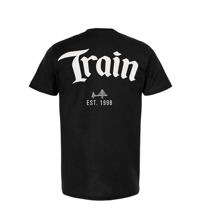 Black t-shirt with ’Train’ printed in large white letters, featuring a small bridge icon and ’EST. 1998’ underneath.