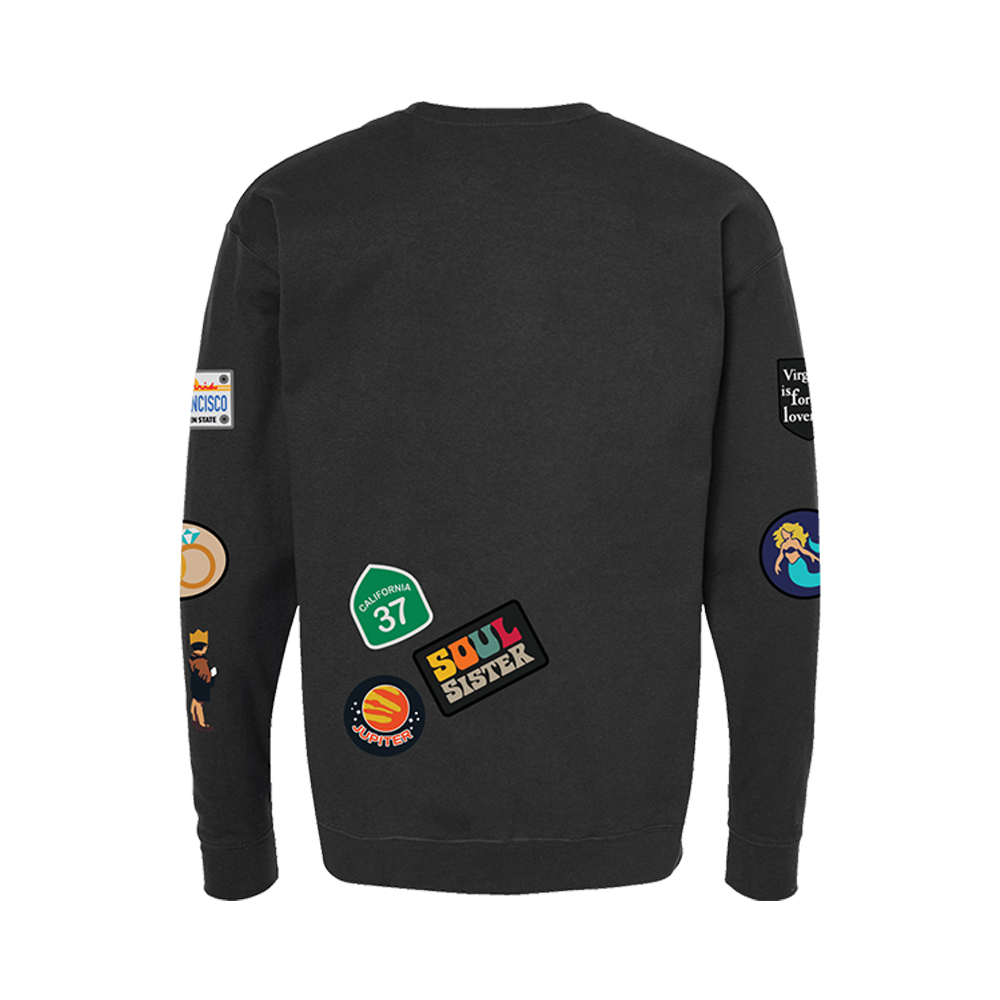 Black sweatshirt with various colorful patches and logos on the sleeves and back.