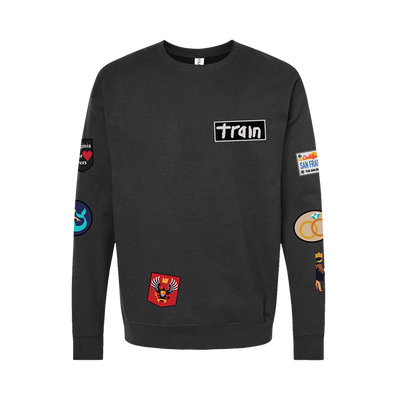 Black sweatshirt with various patches and a ’train’ logo on the chest.